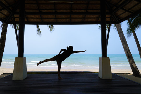 Silhouette Young Woman Practicing Yoga In Pavilion 