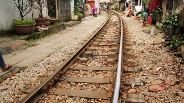 train passing through streets of hanoi slums, vietnam