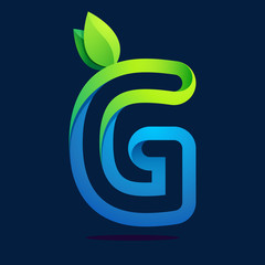 Obraz premium G letter with green leaves and water waves.