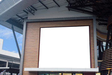 Blank poster billboard wall with copy space for your text message or content in modern shopping mall on a cloudy day.