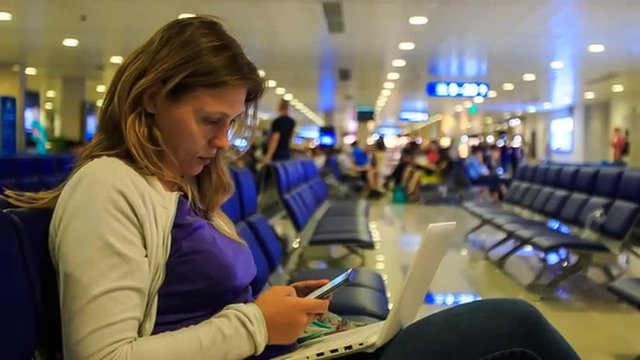 Closeup Blond Girl Works on Laptop Answers sms in Terminal