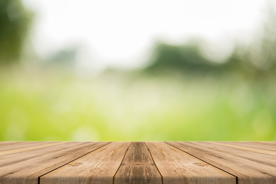Wooden board empty table in front of blurred background. Perspective brown wood over blur trees in forest - can be used for display or montage or mock up your products. your products. spring season.
