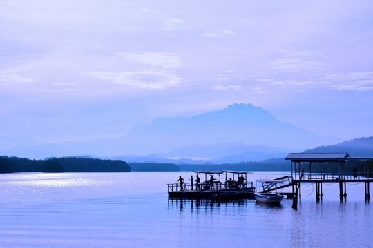 View of Mount Kinabalu in the far horizon seen from the Jetty Mengkabong, Sabah Borneo, Malaysia. After sunrise.