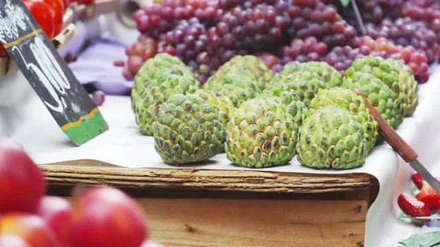 Slow motion shot of sugar apples and other fruits at a market in Rio de Janeiro, Brazil