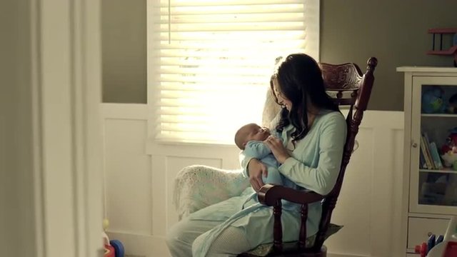 Royalty Free Stock Footage of Mother with baby in a rocking chair.