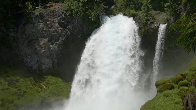 Slow motion, tilt down view of Sahalie Falls in Central Oregon's Willamette National Forest.