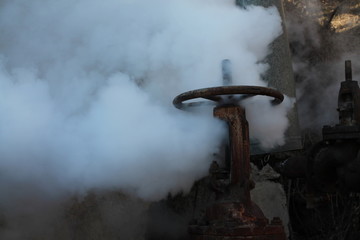 Steam escapes from the valve installed on the pipeline