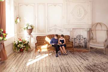 Children reading book in living room