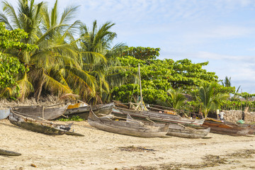 Tropical beach in Madagascar with wooden sailor boats on the shore