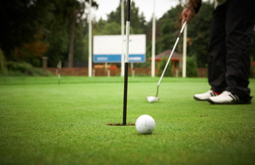 Golf player's legs on grass field.