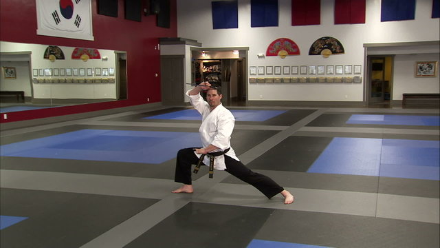 Martial arts instructor using sais in a karate studio.