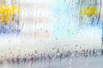 Close up rain drops on the window  with blur light