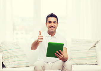 smiling man working with tablet pc at home