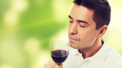 happy man drinking red wine from glass