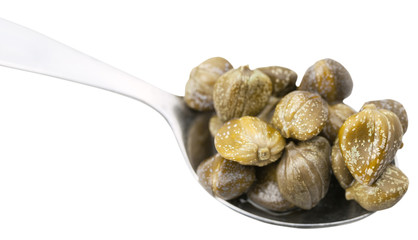 pickled capers in spoon close up isolated