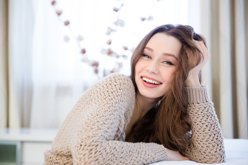 Happy lovely relaxed young woman sitting at home
