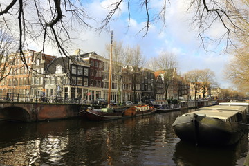 View of Amsterdam canal, typical dutch houses and boats, Holland, Netherlands.