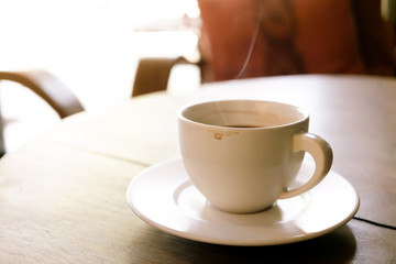 Cup of coffee on wooden table