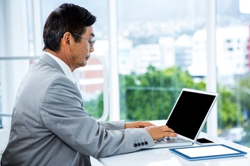 Businessman using his computer 