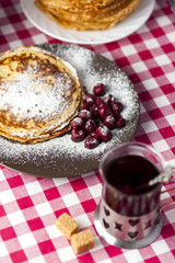 Pancakes with cherries and sugar powder