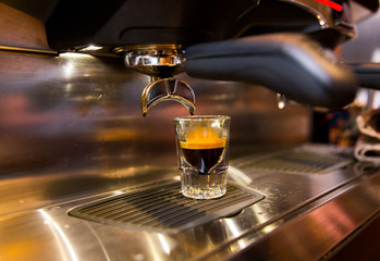 close up of espresso machine making coffee