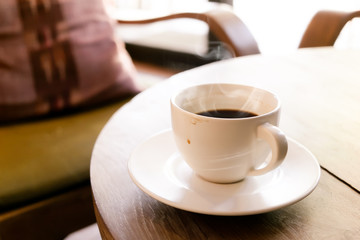 Cup of coffee on wooden table