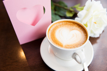 close up of greeting card with heart and coffee