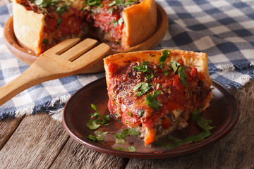 Piece of Chicago deep dish pizza closeup on a plate. horizontal   © FomaA