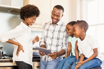 Happy family looking at tablet