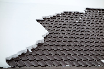 Modern roof covered with tile effect PVC coated metal roof sheets with snow