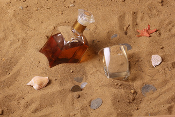 Desert bottle of whiskey and old coins