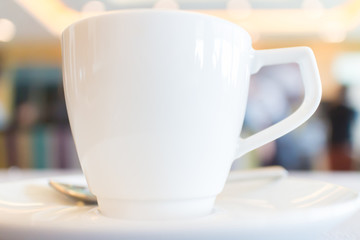 Focus on white tea cup with blurred background of conference bre