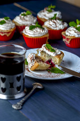 Cupcake with cherry and pineapple on white plate