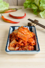 kimchi with Chopsticks on wooden table, korean traditional food