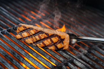 stages of cooking salmon on the grill