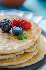 Close view on pancakes stack with fruit