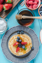 Overhead view on pancakes stack with fruit