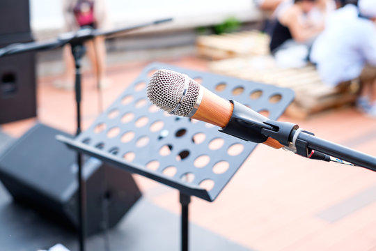 Close up of microphone in concert or conference room with blur p
