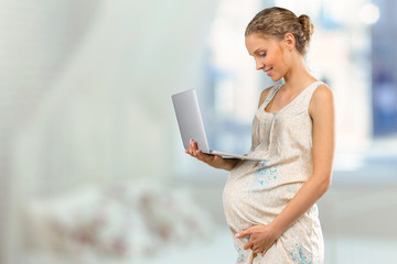Portrait of the young happy smiling pregnant woman