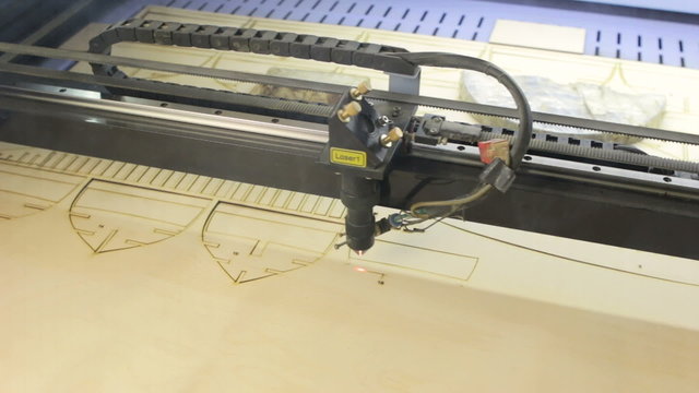 Laser cutting machine at work.  Cuting patterns for ship model