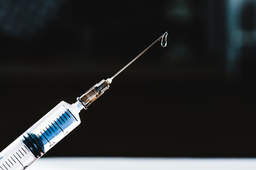 Syringe with pouring medicine close up