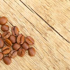 Well roasted coffee beans on old rustic wooden table - studio shot