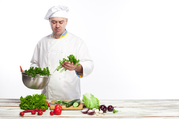 Chef cooking fresh vegetable salad in his kitchen