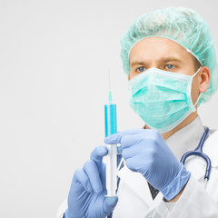 Doctor with syringe in hands preparing for injection - close up shoot