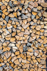 Chopped wood log stored as wall for winter