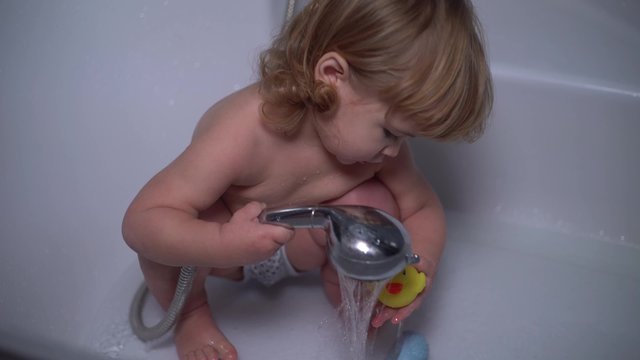 4K little cute baby duck in the shower washes