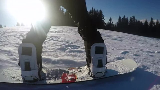 Snowboarding with sun at the background