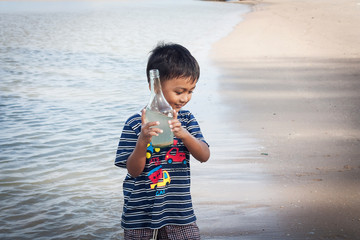 cute little boy play at the beach