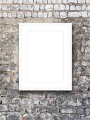 Close-up of one white picture frame on stone wall background