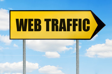 Web traffic Sign -Yellow road sign with arrow pointing right against blue cloudy sky